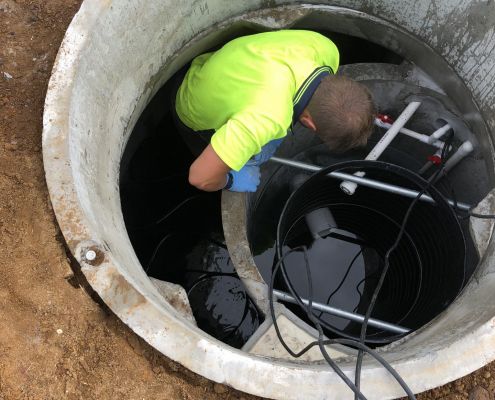 Cullen servicing the inside of a septic tank